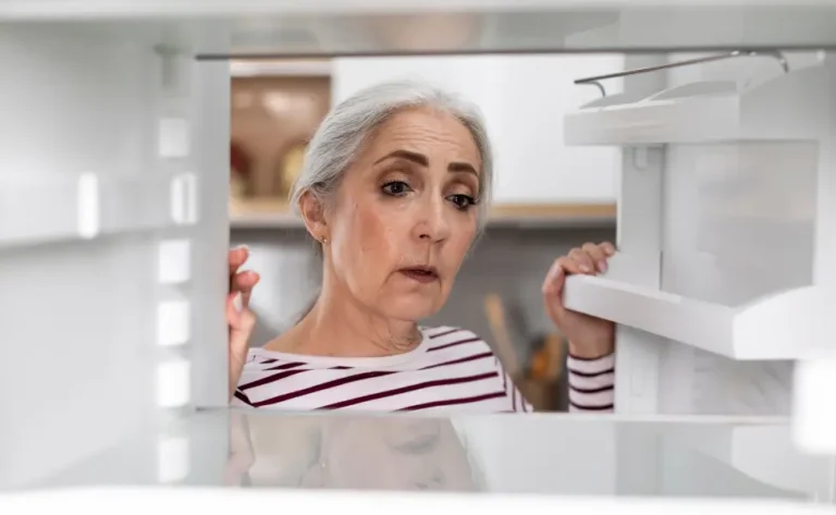 older Woman looking in fridge