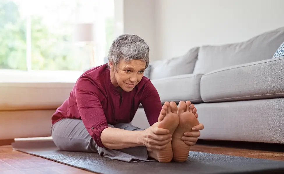 woman gentle stretching at home